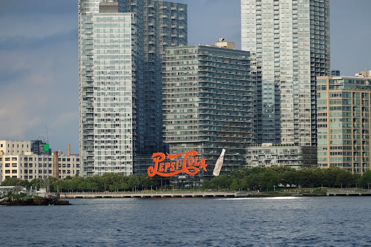 Sign On Shore In Coastal City Near Modern Buildings