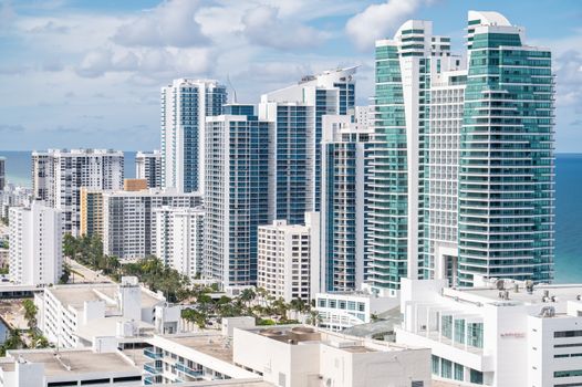 Aerial view of Hollywood, Florida's modern skyline along the coast with high-rise buildings and ocean views.
