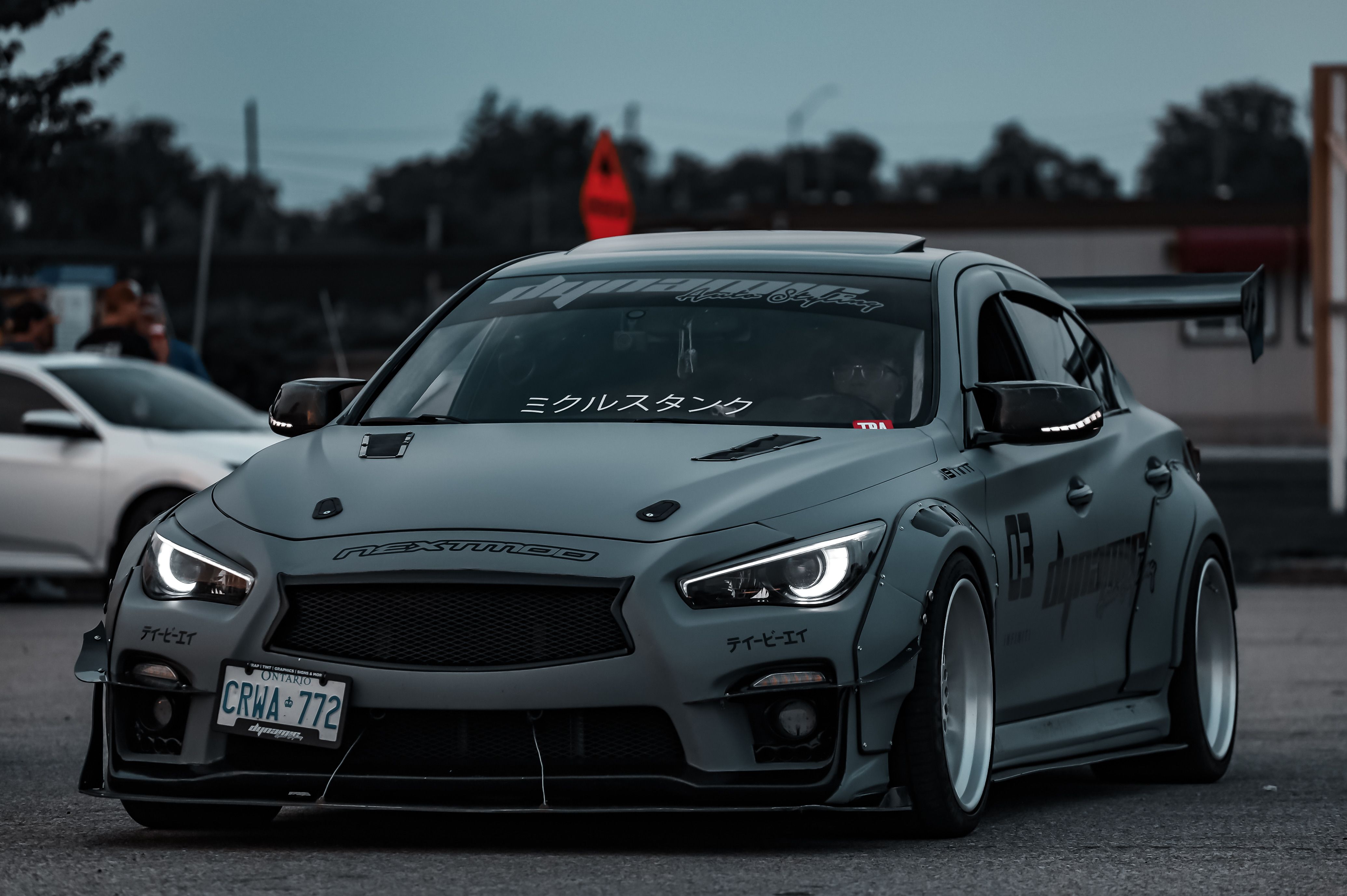 Grey Infinity Sports Car on a Parking Lot · Free Stock Photo