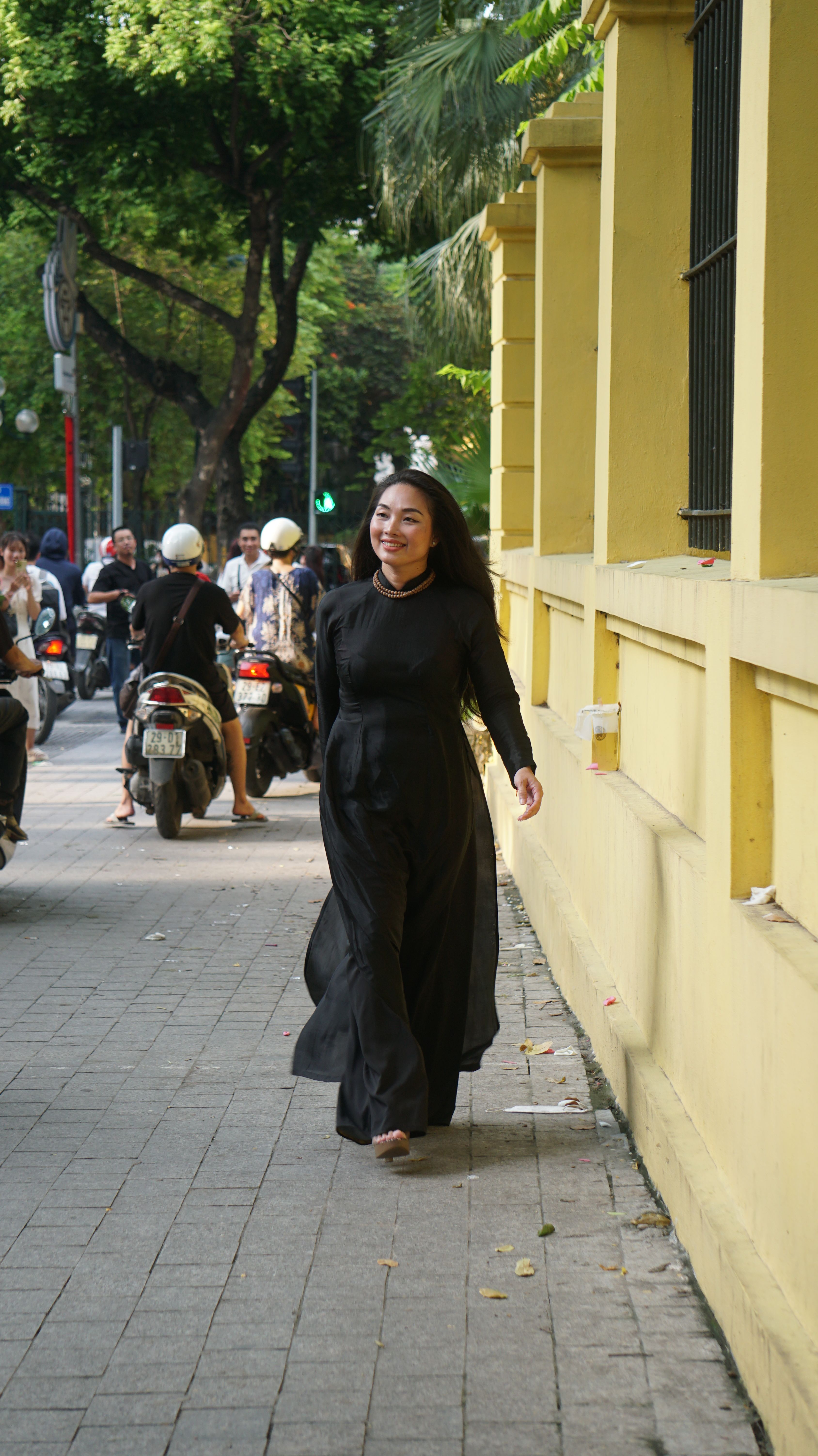 Smiling Woman Walking in Black Dress · Free Stock Photo