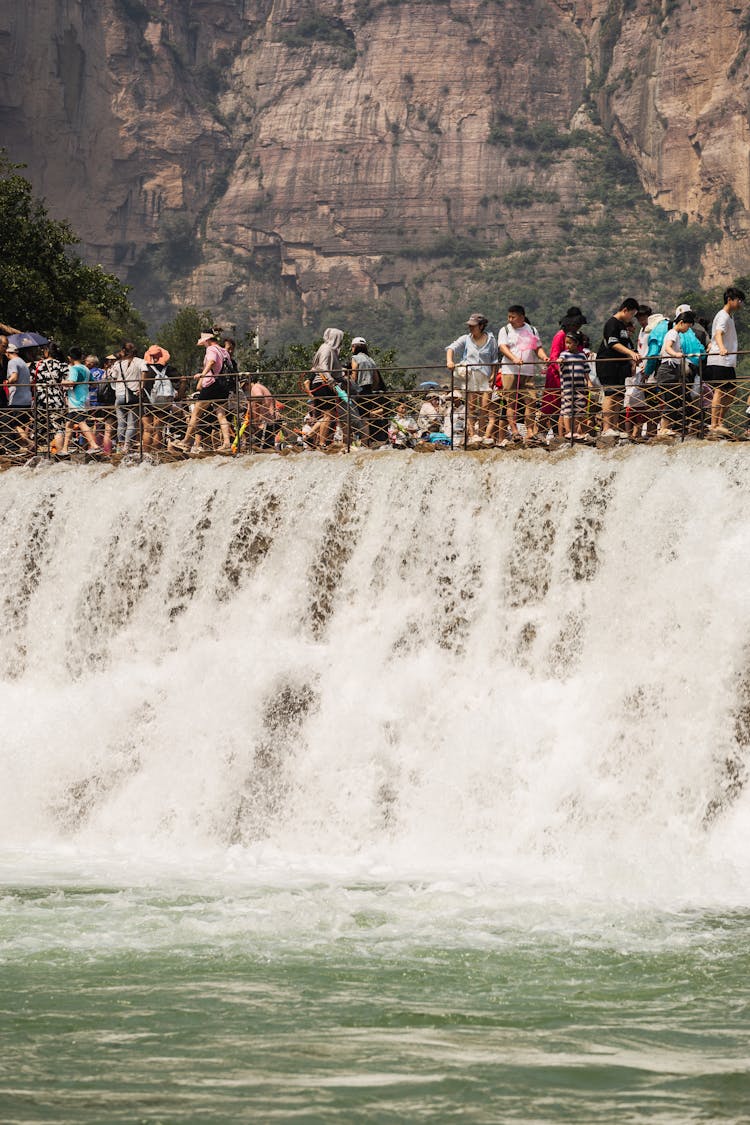 Crowd Watching A Waterfall