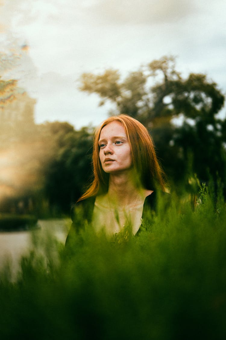 Young Woman On A Grass Field 