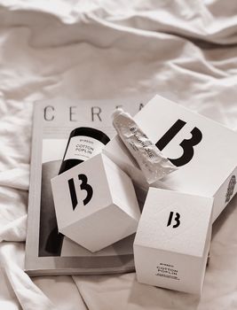 Stylish display of luxury beauty products with minimalist design on a magazine backdrop.