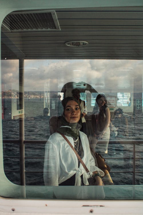 Woman in Headscarf Standing in Ferry Deck