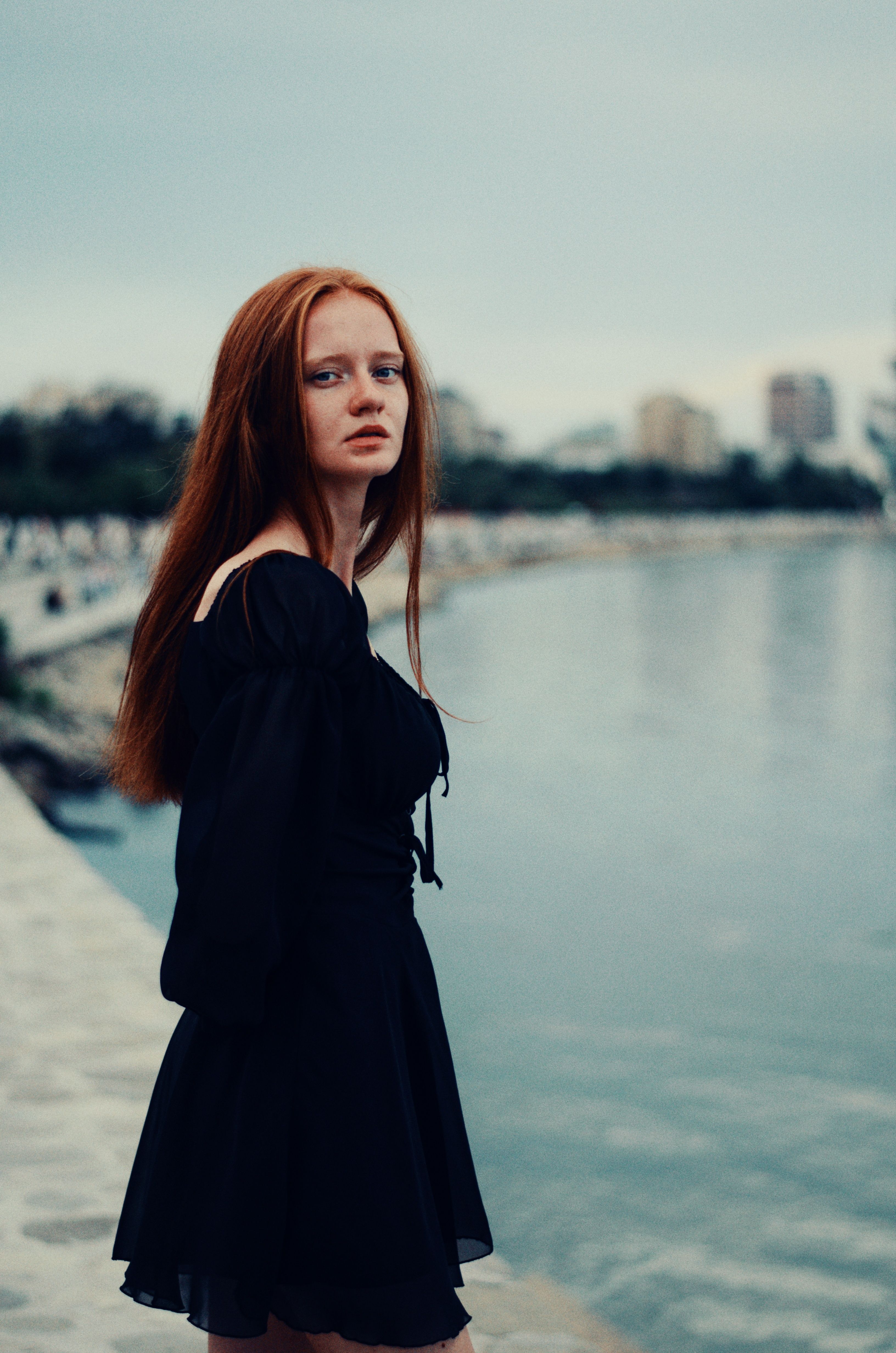 Woman in a Black Dress Standing on a Beach · Free Stock Photo