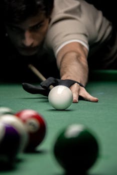 A skilled pool player in focus aiming a precise shot on the billiards table.