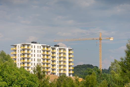 View of modern apartment building and construction crane in Trzebinia, Poland.