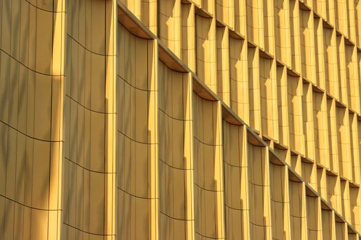 Golden abstract architectural details of a modern building facade in Jönköping, Sweden.