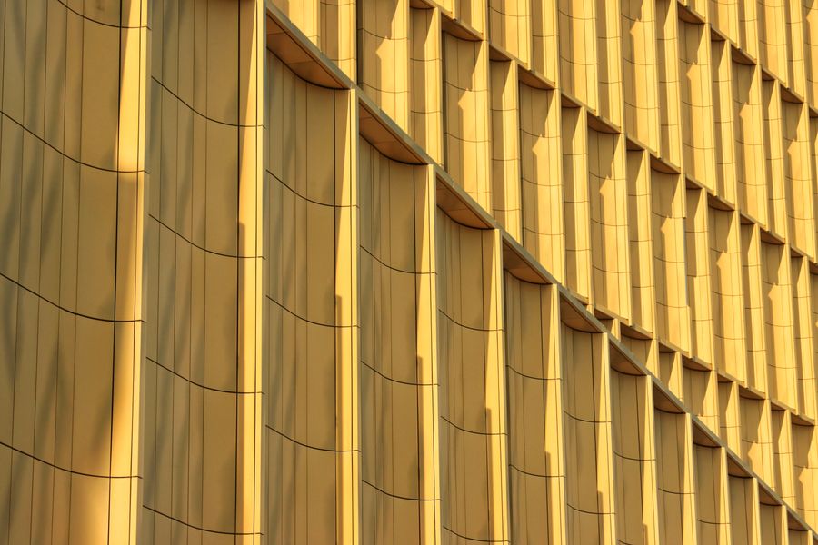 Golden abstract architectural details of a modern building facade in Jönköping, Sweden.