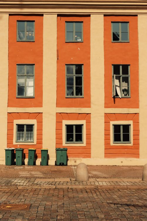 Free A vibrant building facade with windows and green bins in Jonkoping, Sweden. Stock Photo