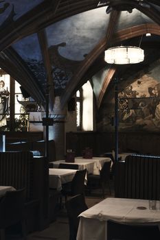 Elegant interior of a historic restaurant in Munich, Germany, with Gothic arches.