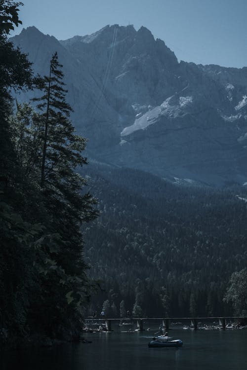 Lake and Forest under Mountains behind