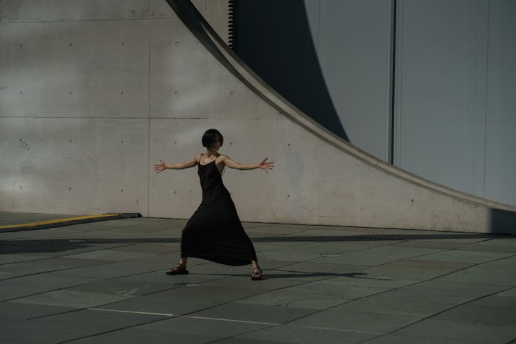 Woman In Black Strap Dress Dancing City