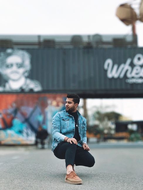 Stylish young man posing in front of urban graffiti art, showcasing modern fashion. Stylish young man posing in front of urban graffiti art, showcasing modern fashion.
