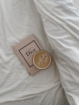 Enjoy a relaxing morning in bed with a coffee and a fashion book.