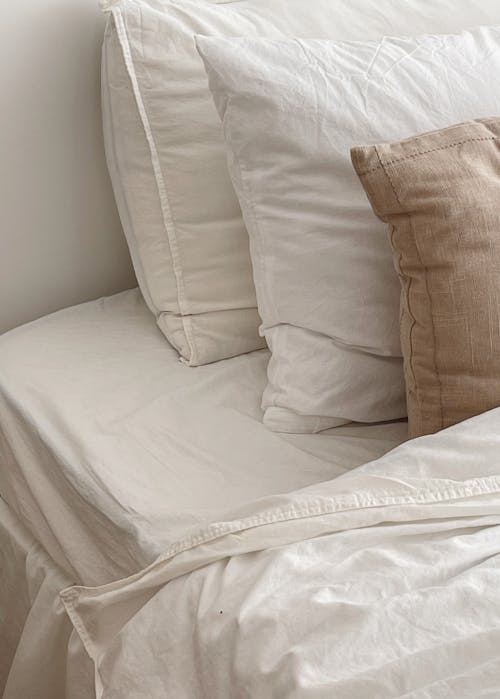 Free A Bed with White Sheets  Stock Photo