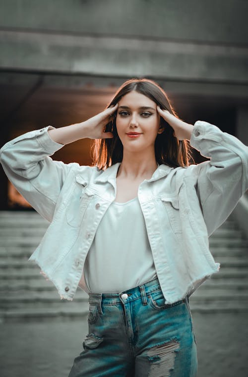 Young Woman in White Jacket and Jeans