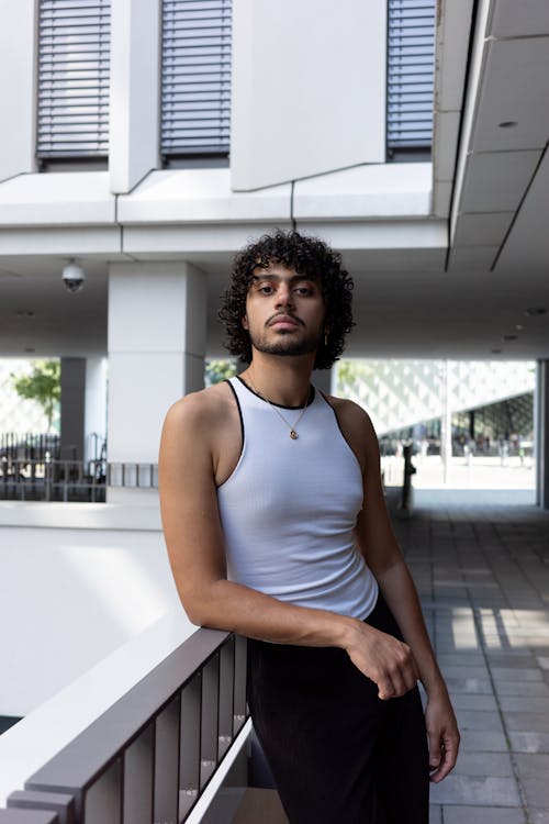 Young Man with Moustache Posing on Building Terrace