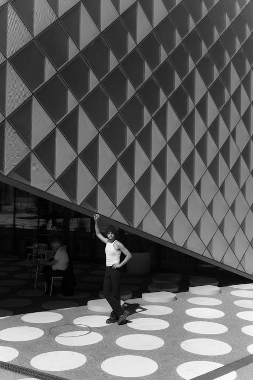 Young Man Posing near Contemporary Building