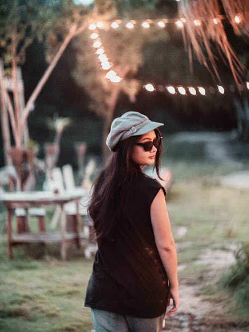 Woman in Cap and Sunglasses