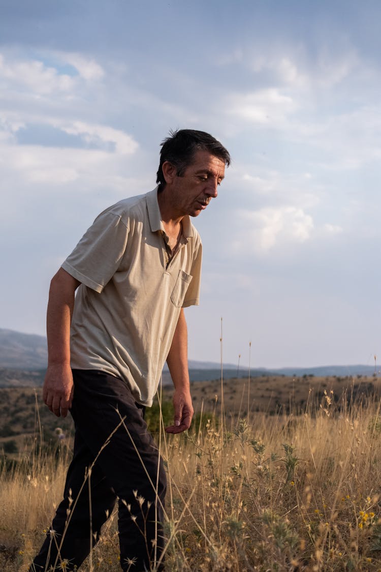 Man Walking On Meadow