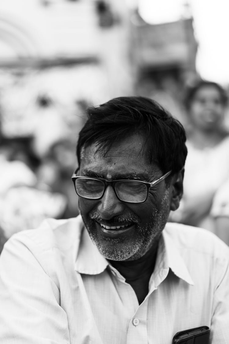 Candid Black And White Portrait Of A Smiling Man Standing Outside 