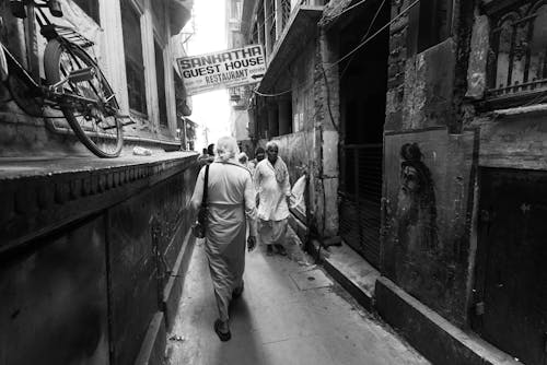 People Walking in a Narrow Alley in India in Black and White 