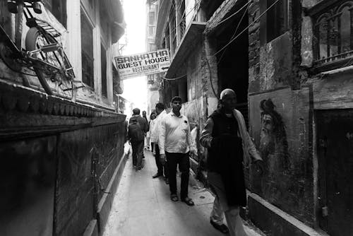 People in Narrow Alley in Black and White
