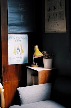 A calm living room corner featuring vintage decor, posters, and a stylish lamp.