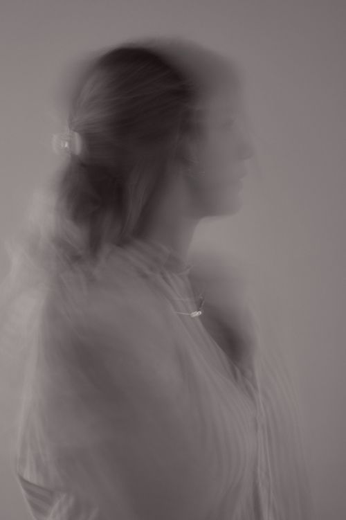 Free Black and white portrait of a woman with motion blur capturing dynamic movement. Stock Photo