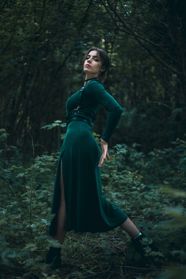 Woman wearing a deep green long-sleeve wrap dress
