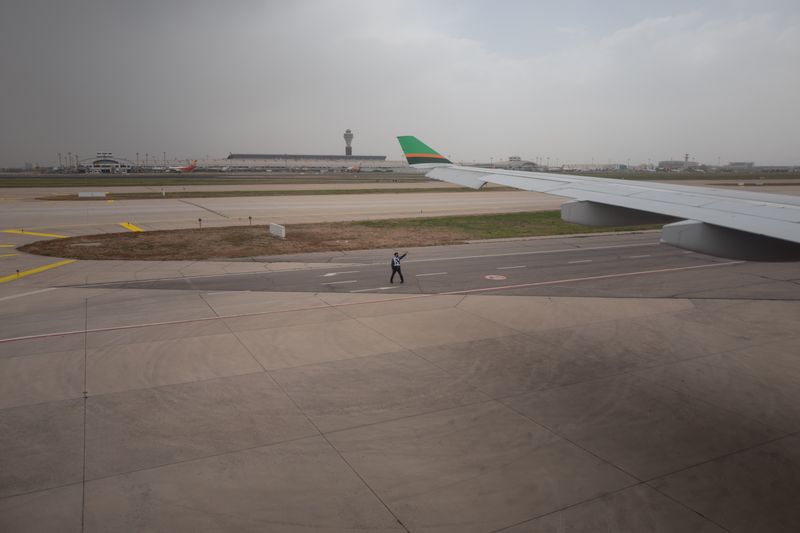 Airport runway hold short markings and yellow centerline visible on a clear day at a general aviation airport
