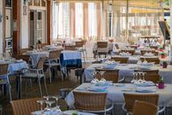 Charming outdoor dining area with neatly set tables in Sitges, Spain, bathed in natural light.