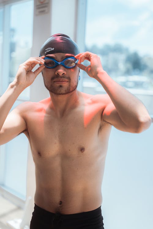 A Man Wearing a Swimming Cap and Goggles 