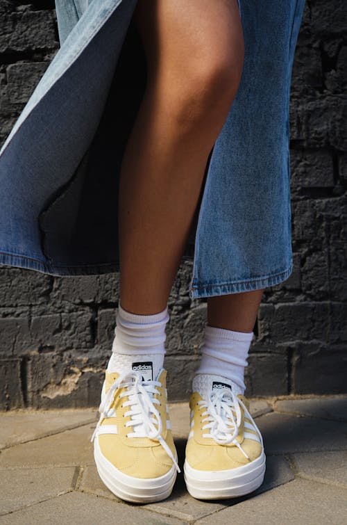 Woman in Yellow Trainers and White Socks