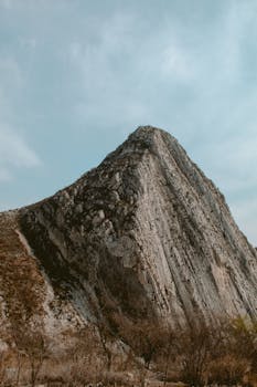 A striking rocky hill in Santa Catarina, N.L., Mexico under a clear sky.