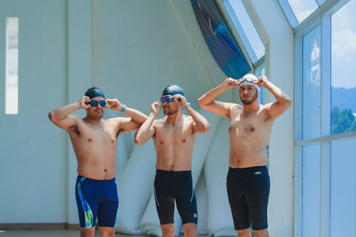 Three Shirtless Swimmers