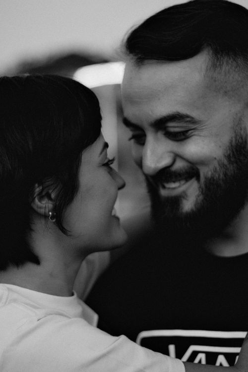 Free Close-up of a happy couple smiling at each other in black and white. Stock Photo