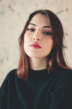 Close-up portrait of a young woman with elegant makeup and brunette hair.