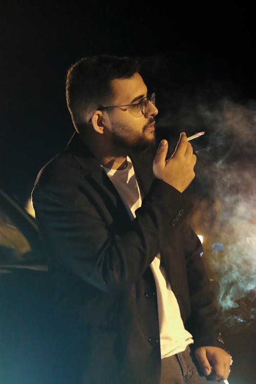 Man Smoking Cigarette at Night