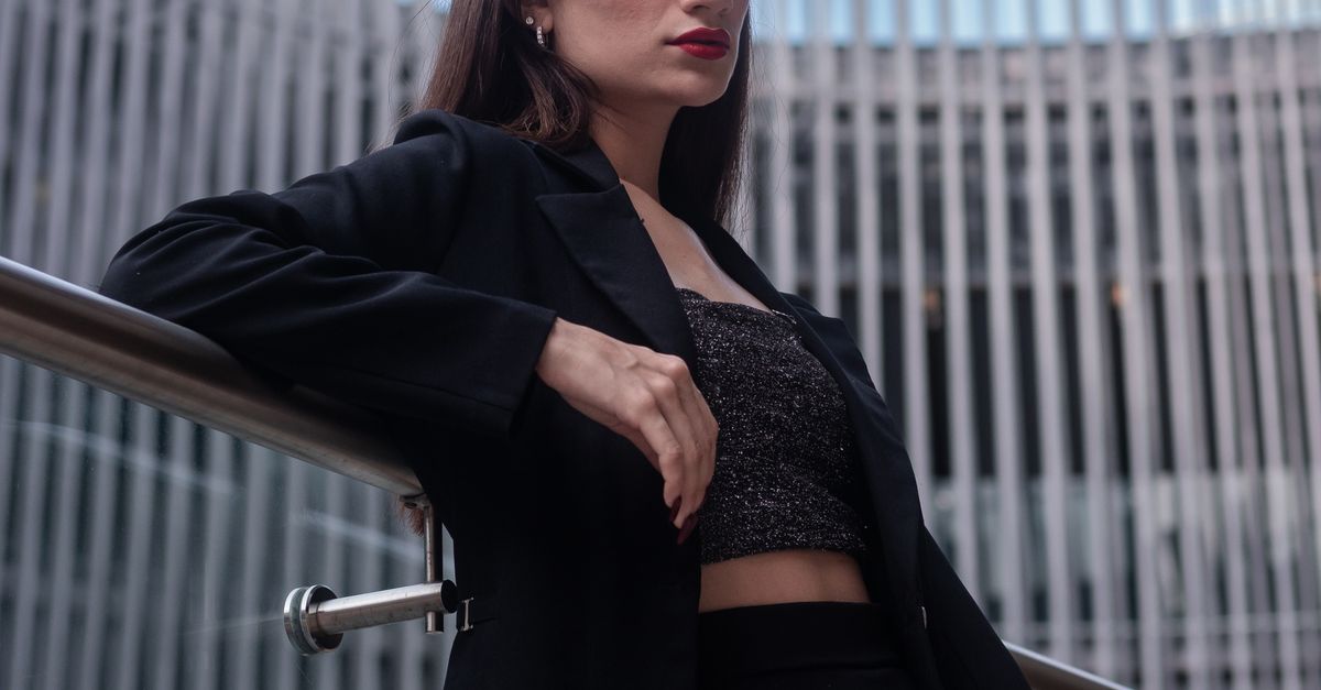 Slumped Against Railing Woman Resting against Railing under Modern Building · Free Stock Photo