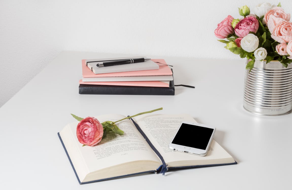 Free Book On A White Wooden Table Stock Photo