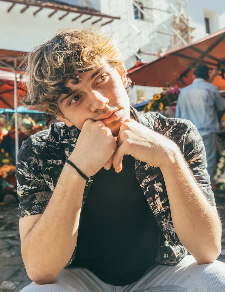 Young Man Posing In Black T-shirt And Aloha Shirt