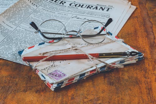 Free Letters And An Eyeglass On Table Stock Photo