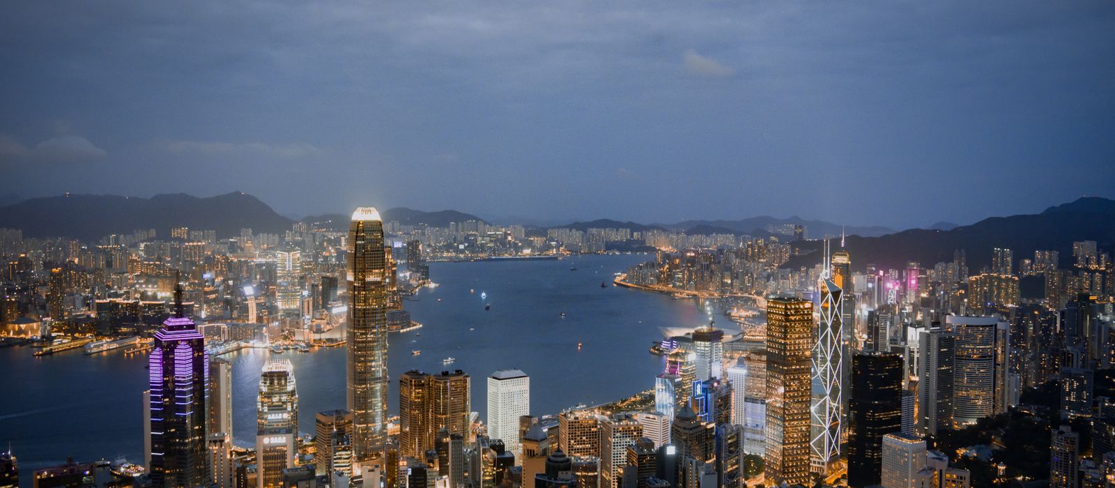 A breathtaking view of Hong Kong's illuminated skyline and harbor at night. — flights from Penang to Hong Kong