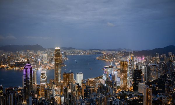 A breathtaking view of Hong Kong's illuminated skyline and harbor at night.