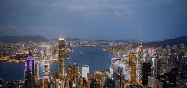 A breathtaking view of Hong Kong's illuminated skyline and harbor at night.