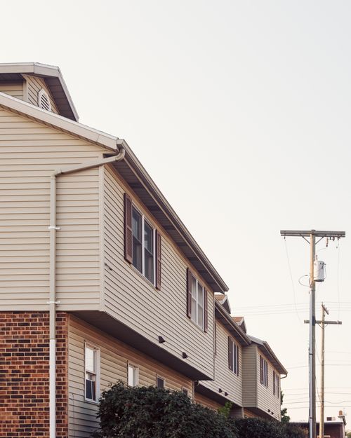 Row of brick suburban homes on a quiet residential street