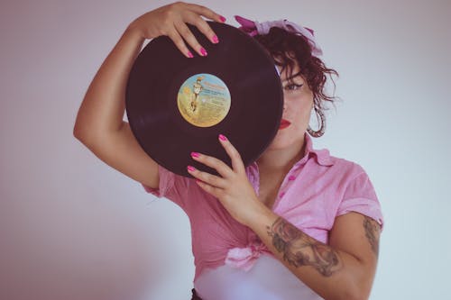 Free Woman In Pink Shirt Holding A Vinyl Record Stock Photo
