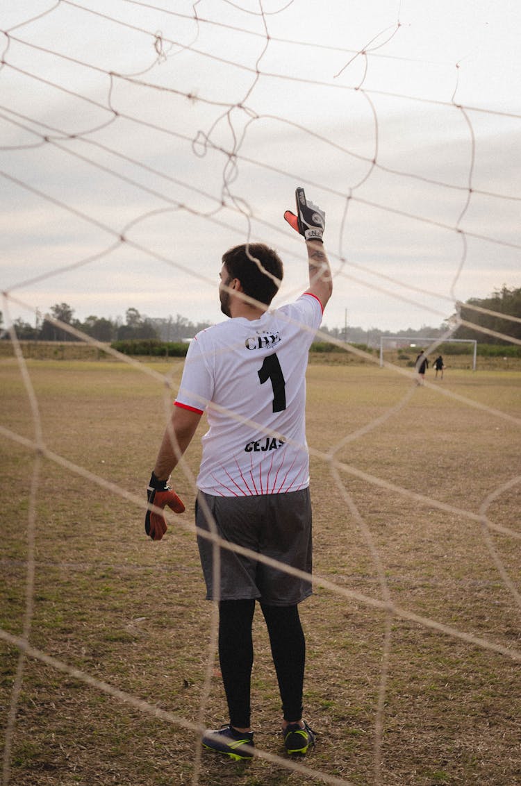 Goalkeeper Standing On A Soccer Pitch